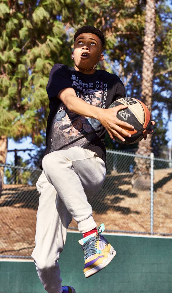 Brit Phelan takes a photo of Nike athlete playing basketball