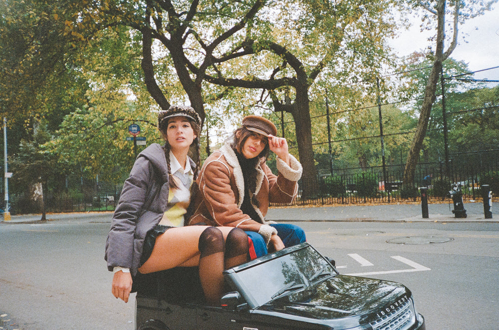 Girls in toy car in NYC with their iphones