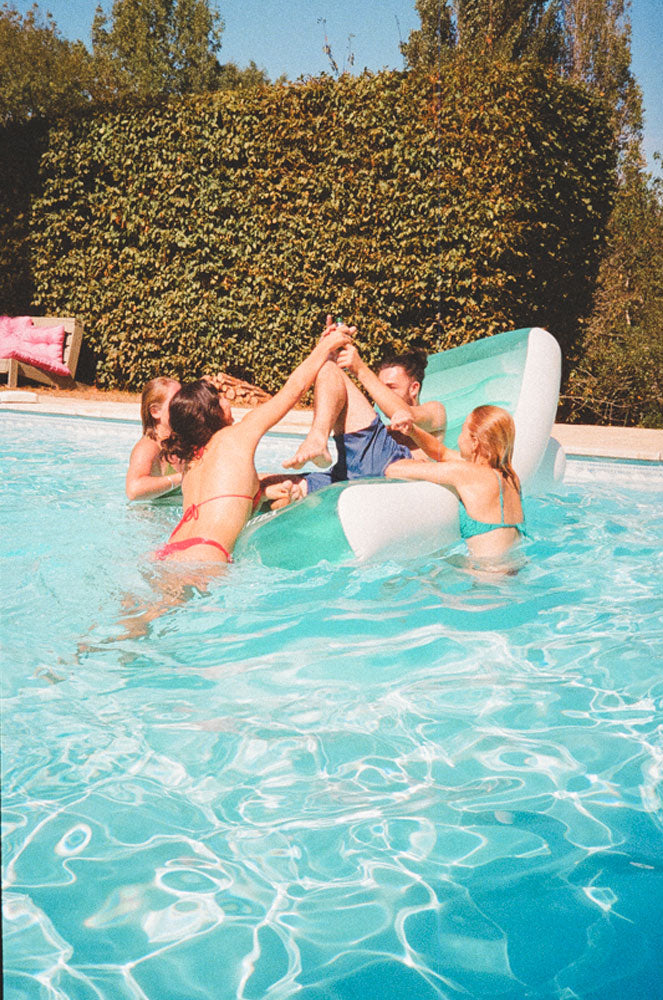 Boy and his bear in the pool with girls